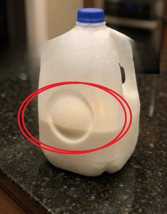 The Purpose of the Circular Dent on Milk Jugs: A Hidden Engineering Marvel
