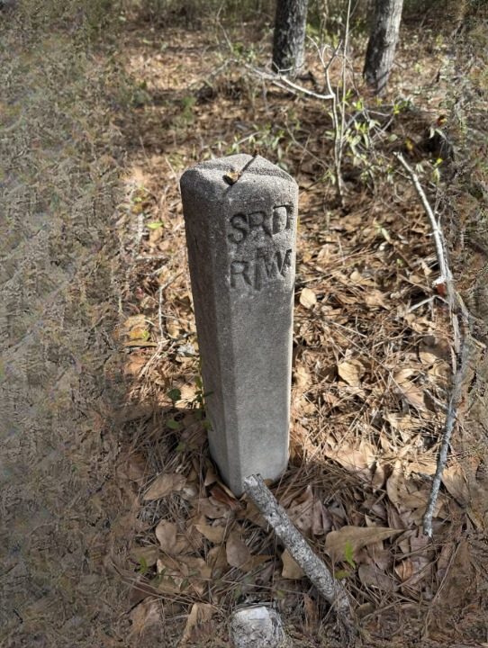 What’s Hiding Beside This Quiet Path? The Small Concrete Marker That Reveals a Forgotten Road and a Piece of Local History