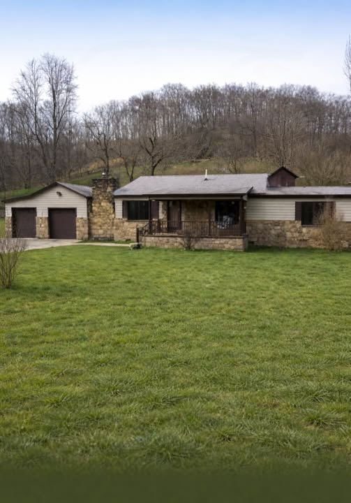 Charming Ranch-Style Home with Stone Accents and Peaceful Outdoor Space