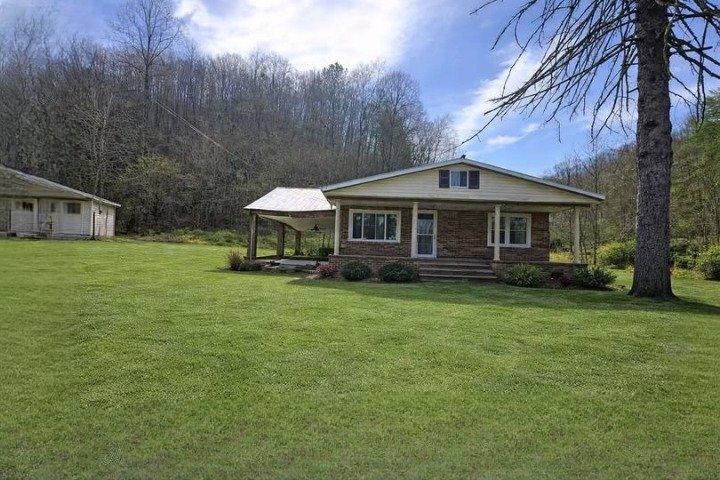 Affordable 6.9-Acre Brick Fixer-Upper with Creek Frontage & Seller Financing Opportunity